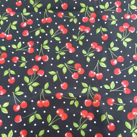 cherries with white polka dots on black fabric swatch